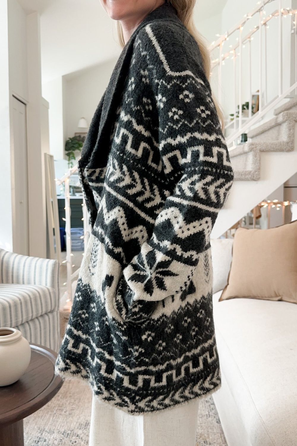 Black geometric jacquard wrap cardigan with shawl collar and pockets.