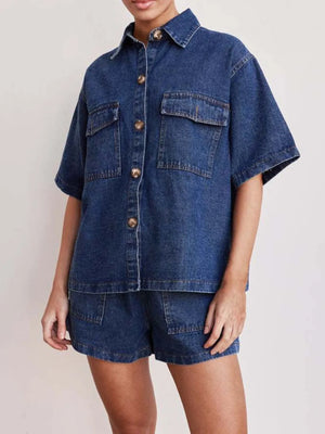 Medium wash denim co-ord set with short sleeve button-up shirt and shorts.