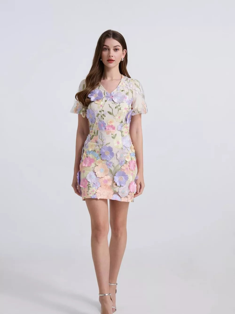 Embroidered floral mini dress with puff sleeves in pastel multicolor fabric with applique flowers.