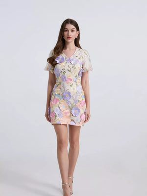Embroidered floral mini dress with puff sleeves in pastel multicolor fabric with applique flowers.