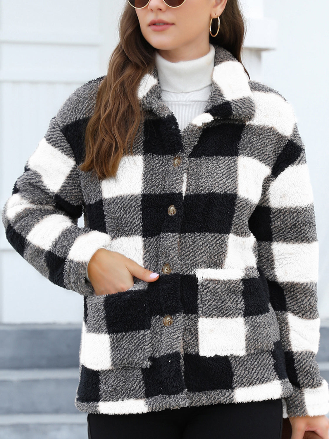 Plaid sherpa overshirt jacket in black and white with button front and pockets.