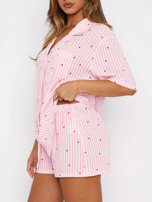Blush pink striped pajama set with red hearts, collared button-up top and shorts.