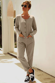 Relaxed linen-blend jumpsuit in khaki with button front and cuffed legs.