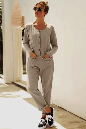 Relaxed linen-blend jumpsuit in khaki with button front and cuffed legs.