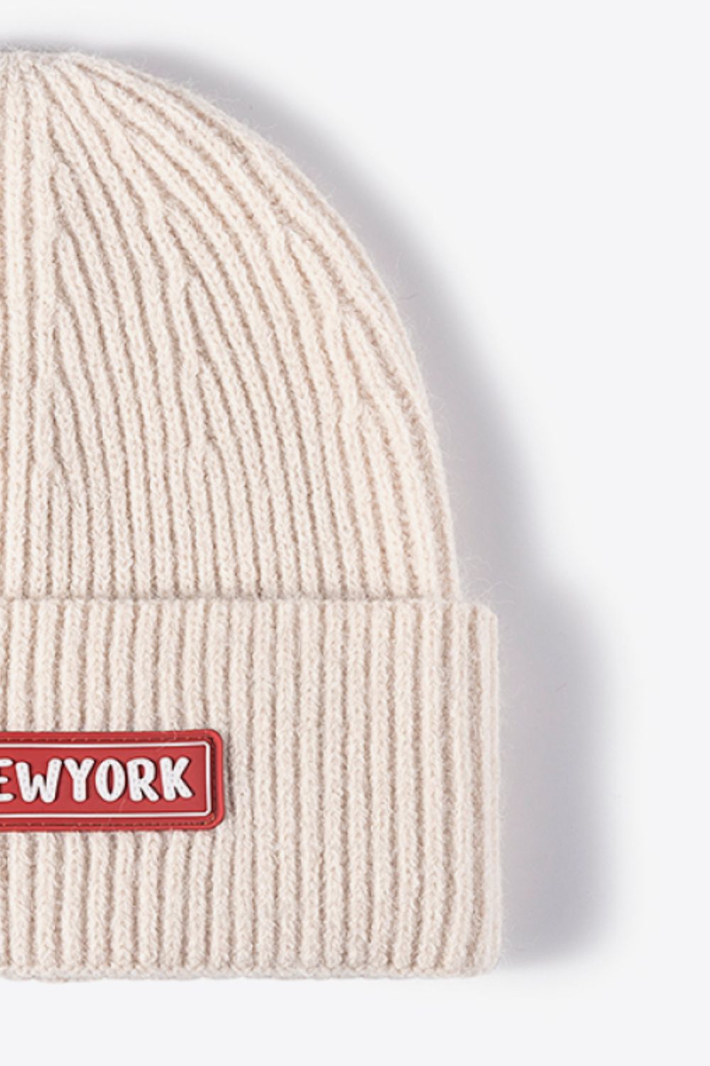 Beige ribbed acrylic beanie with New York patch detail