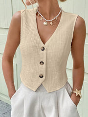 Apricot textured cotton button vest with V-neck and cropped length.