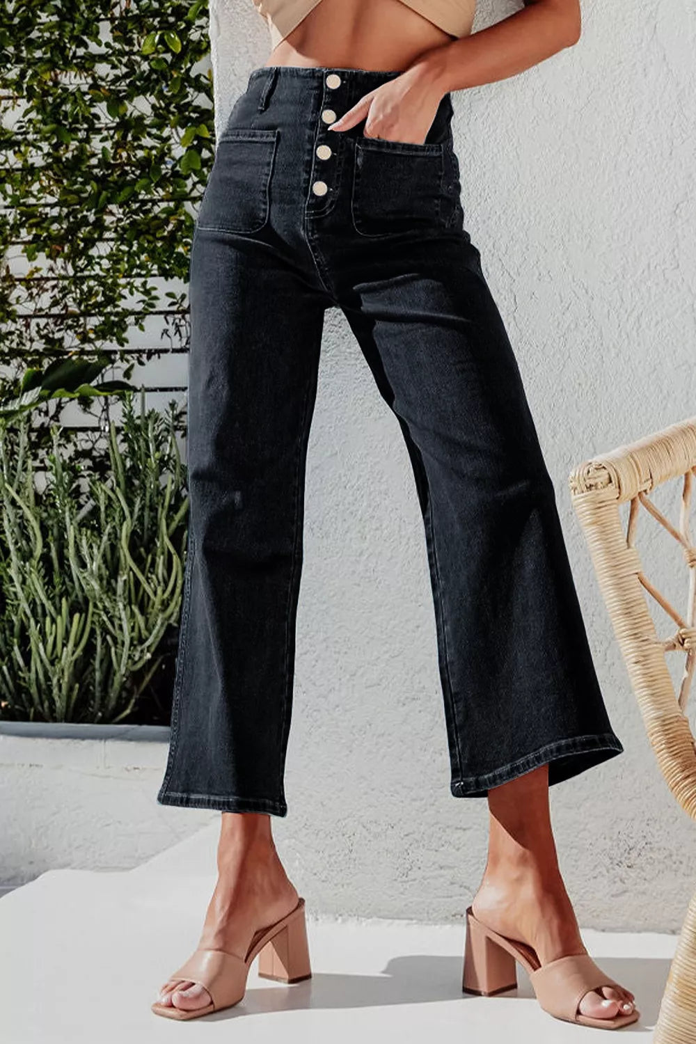 Black denim wide-leg jeans with button-fly and front pockets.