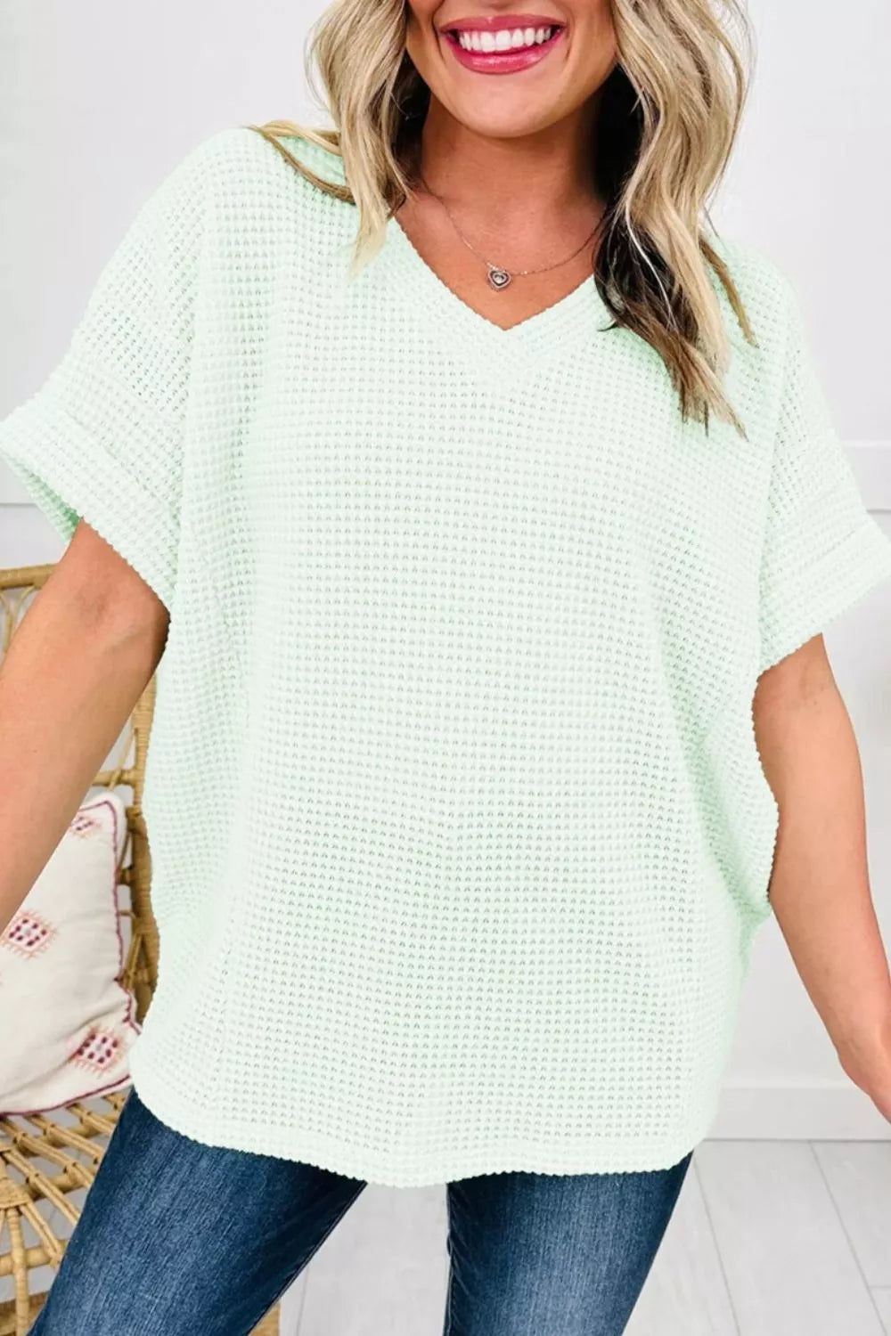 Relaxed light green waffle knit t-shirt with v-neck and cuffed short sleeves.