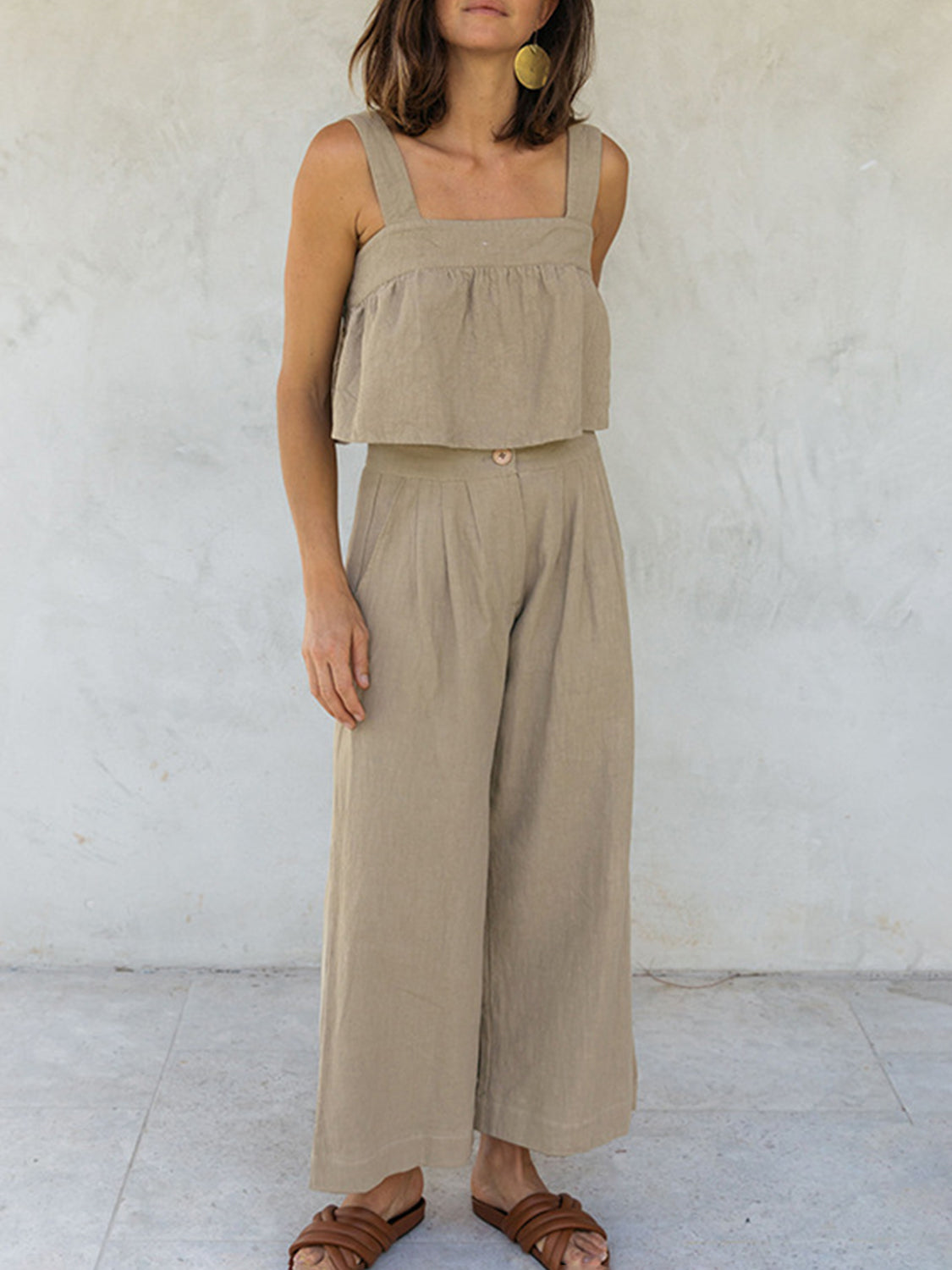 Khaki linen crop top with square neckline and culotte pants with button detail.
