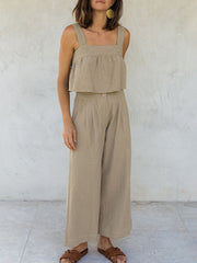 Khaki linen crop top with square neckline and culotte pants with button detail.