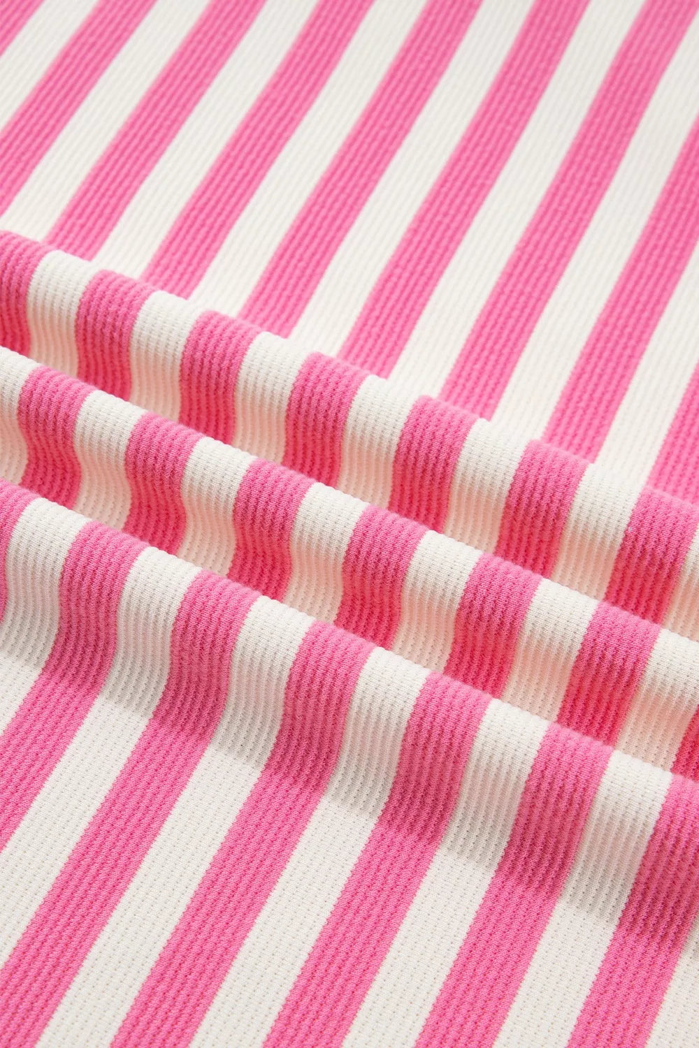 Polyester short sleeve tee with vibrant pink and white stripes and a textured knit.
