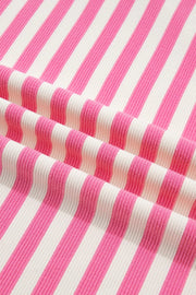 Polyester short sleeve tee with vibrant pink and white stripes and a textured knit.