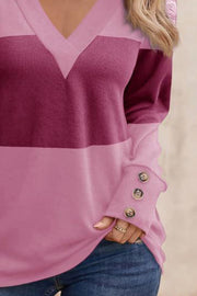 Pink and red-violet geometric V-neck knit top with button cuffs