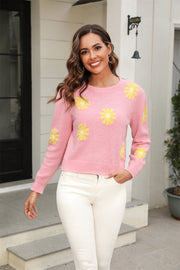 Blush pink acrylic sweater with yellow daisy motif, crew neck, long sleeves.