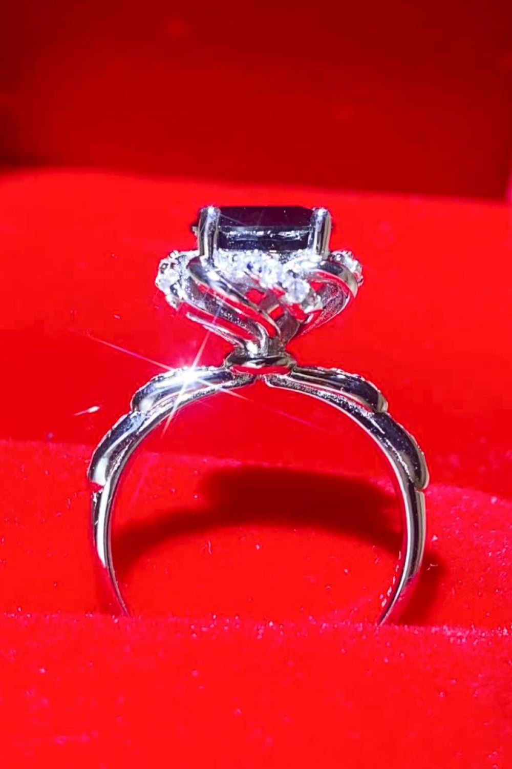 Black moissanite ring with diamond halo and twisted band.