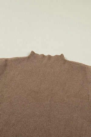 Brown ribbed knit mock neck sweater vest with lettuce edge detail.