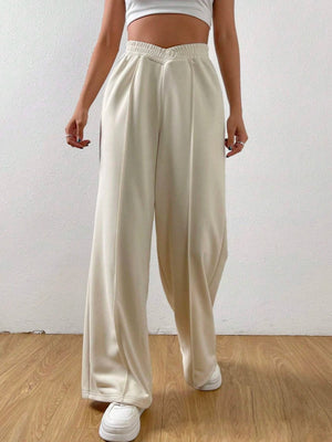 Cream V-waistline palazzo sweatpants with center seams and wide legs.
