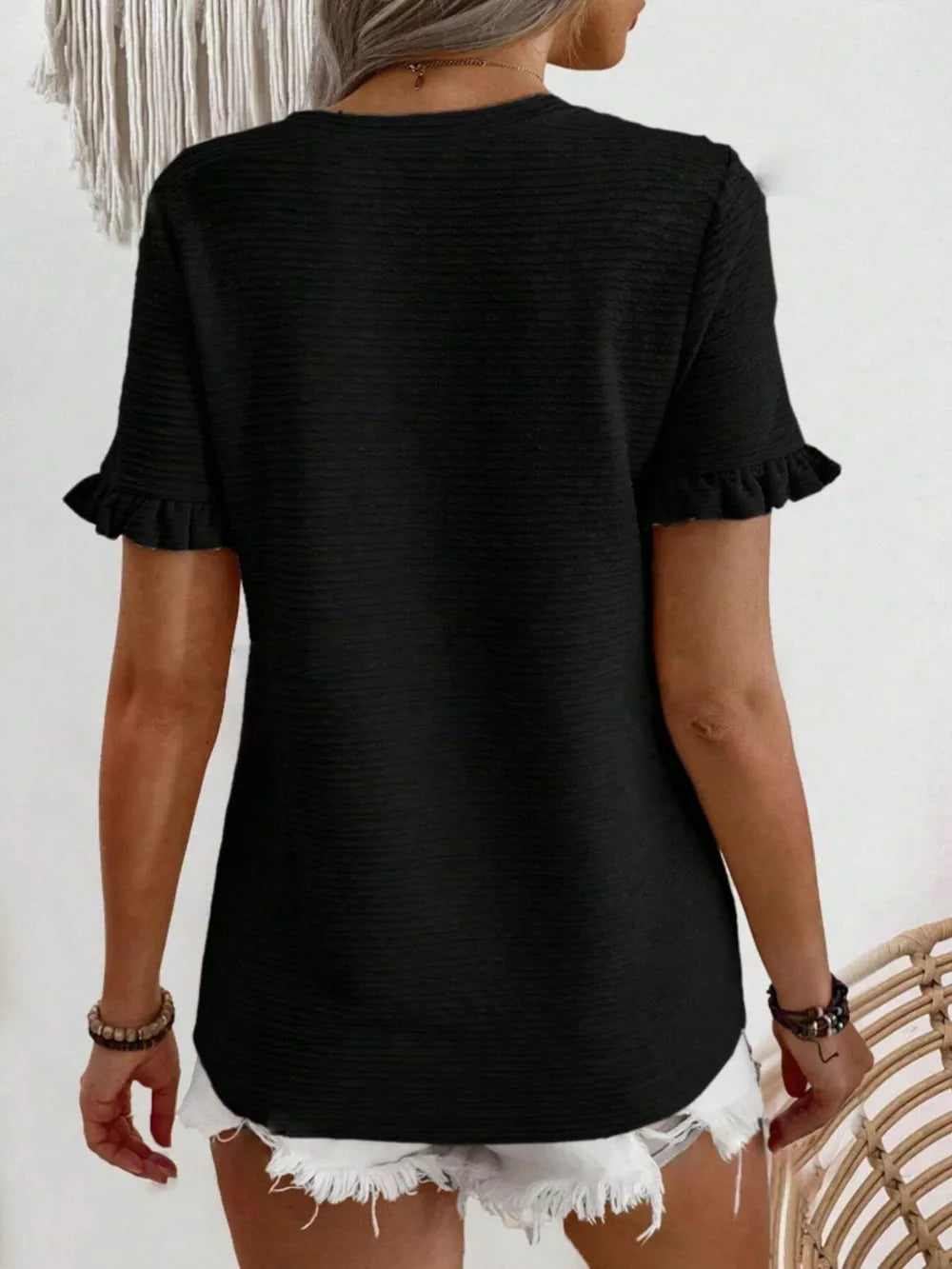 Black textured t-shirt with short ruffle sleeves and crew neck.