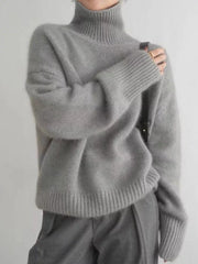 Gray acrylic turtleneck sweater with dropped shoulders and ribbed cuffs and hem.