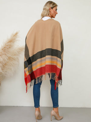 Asymmetric plaid cape with fringe detail in tan with colorful stripes and black accents.