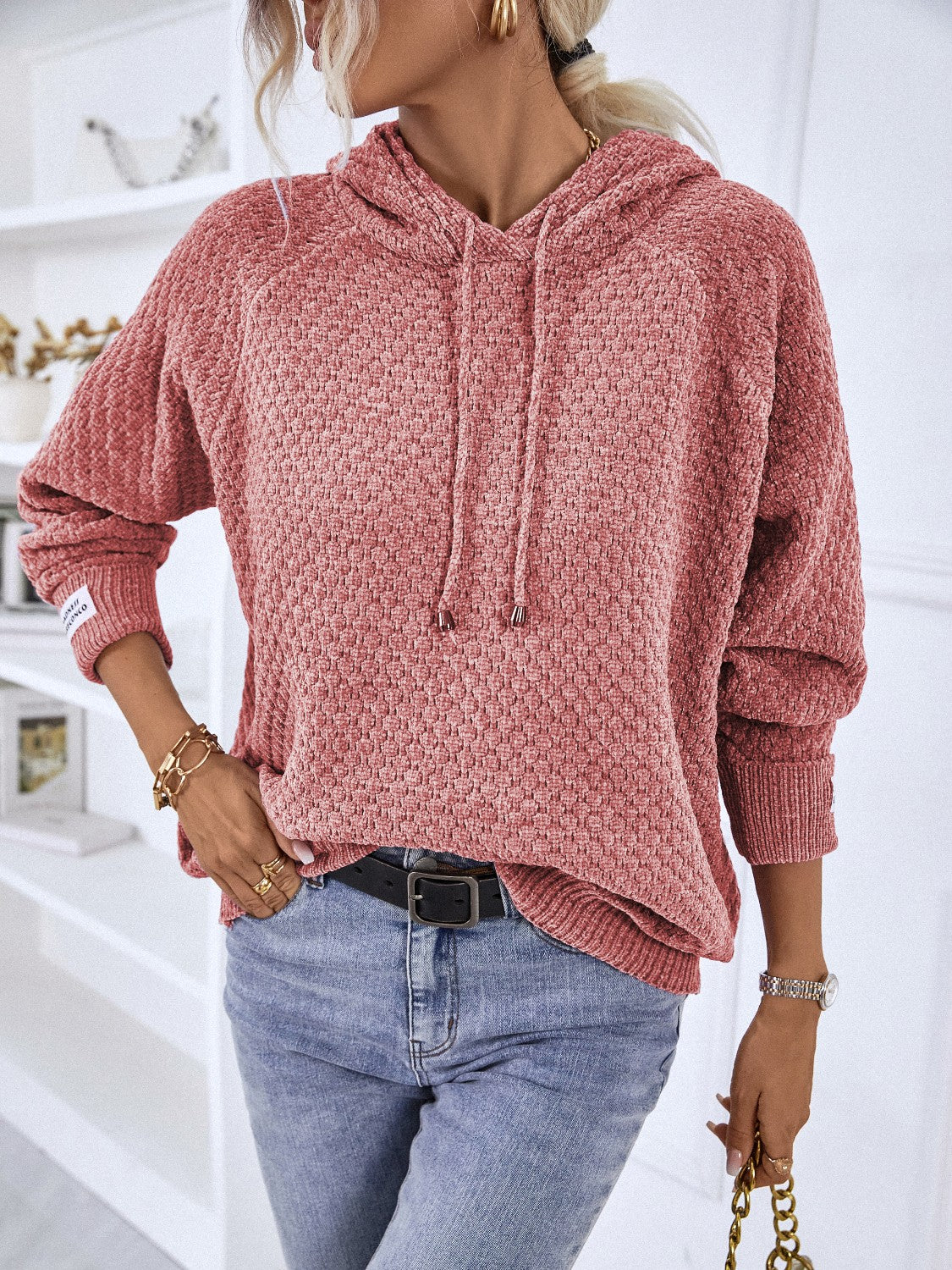 Textured knit raglan sleeve hoodie in burnt coral with drawstring hood and ribbed cuffs.