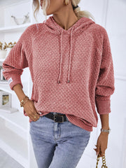 Textured knit raglan sleeve hoodie in burnt coral with drawstring hood and ribbed cuffs.