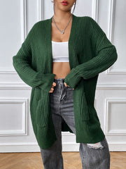 Green ribbed knit longline cardigan with pockets and open front.