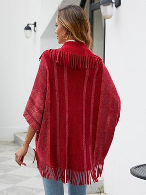 Textured red capelet with fringe and vertical stripes, open front.