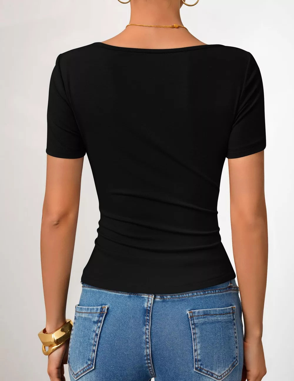 Black asymmetrical fitted maternity t-shirt with short sleeves and a scoop neckline.