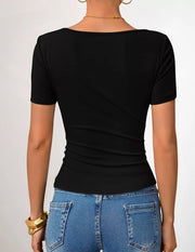 Black asymmetrical fitted maternity t-shirt with short sleeves and a scoop neckline.
