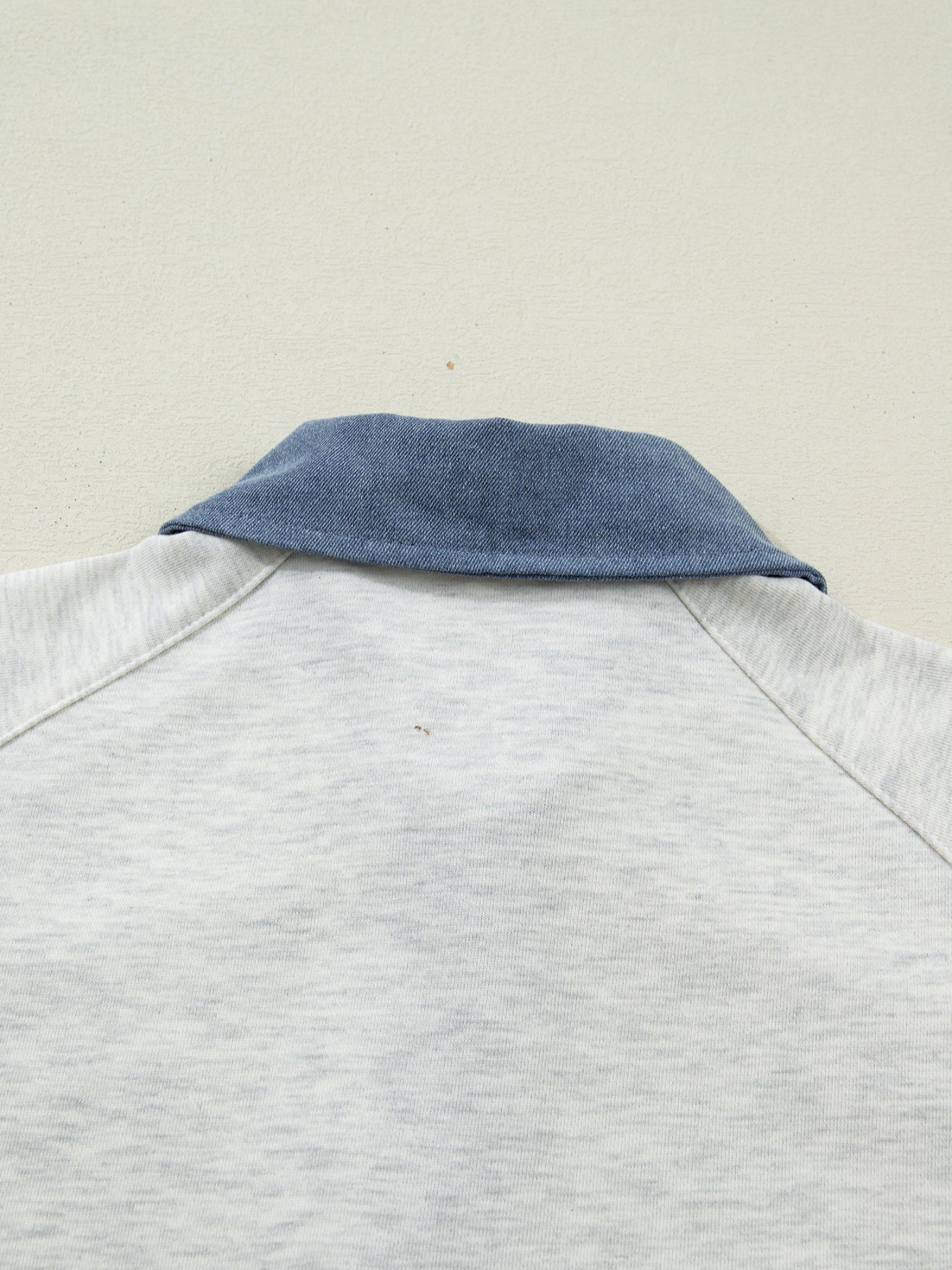 Light grey cotton polo top with blue denim collar detail.