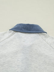 Light grey cotton polo top with blue denim collar detail.