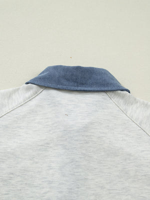 Light grey cotton polo top with blue denim collar detail.