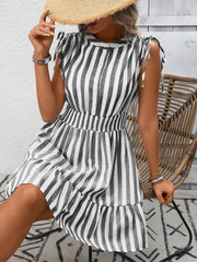 Striped summer dress with tied shoulders, button front, smocked waist, and ruffled hem.