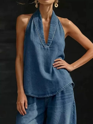 Blue denim halter top with deep V-neck and wide-leg pants ensemble.