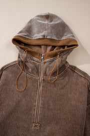 Brown corduroy pullover hoodie with quarter zip and adjustable drawstring hood.