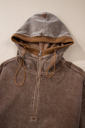 Brown corduroy pullover hoodie with quarter zip and adjustable drawstring hood.