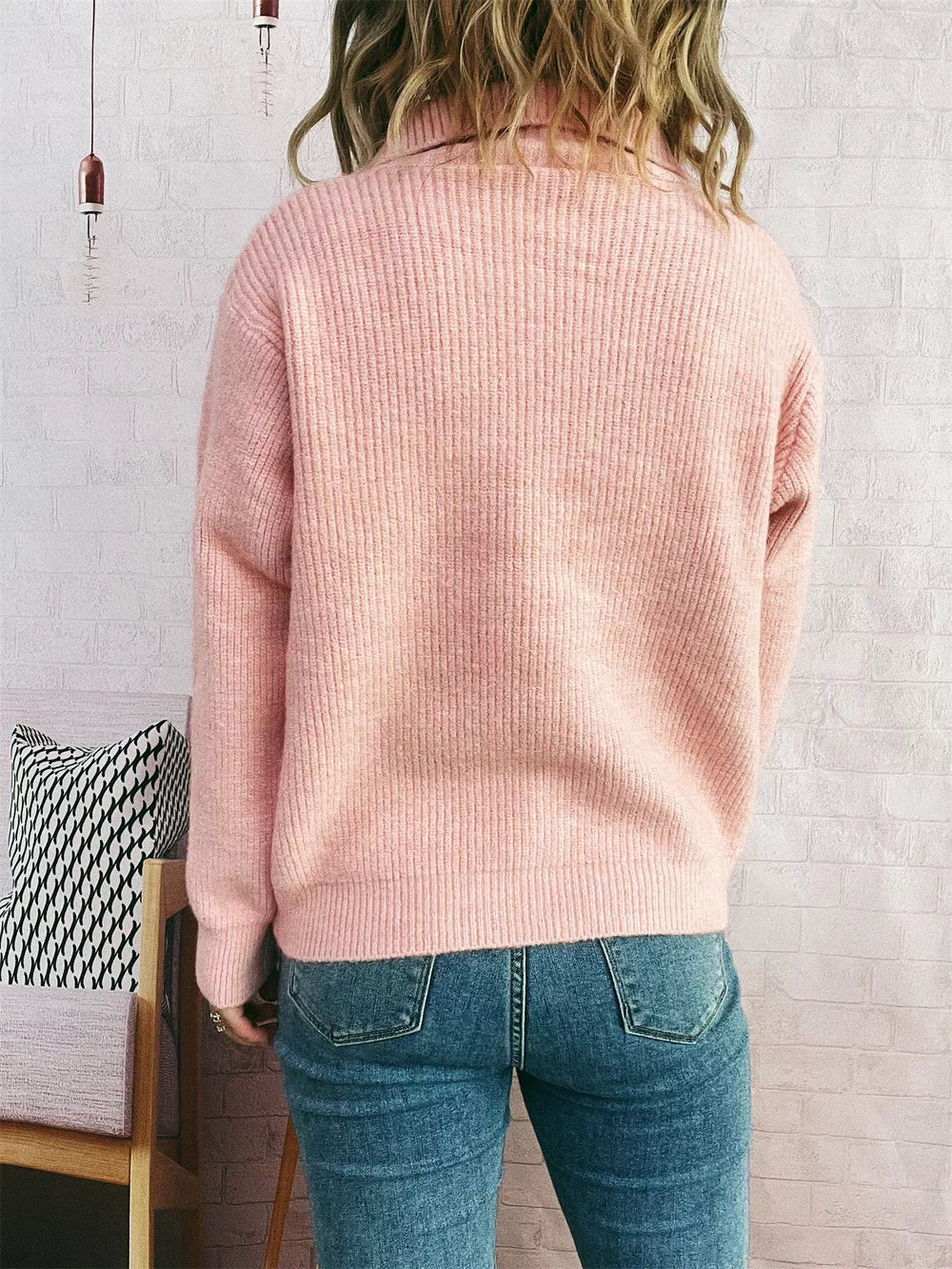 Pink ribbed knit cardigan with polo collar and button-up detail.
