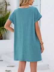 Turquoise V-neck short sleeve pocket dress with cuffed sleeves and a relaxed fit.