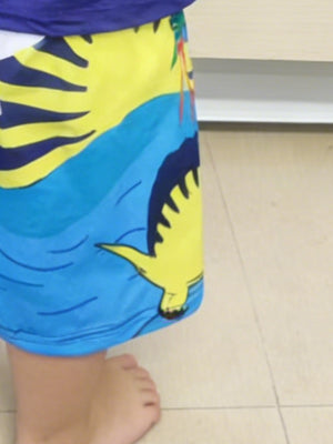 Toddler shorts with yellow dinosaur and blue waves pattern