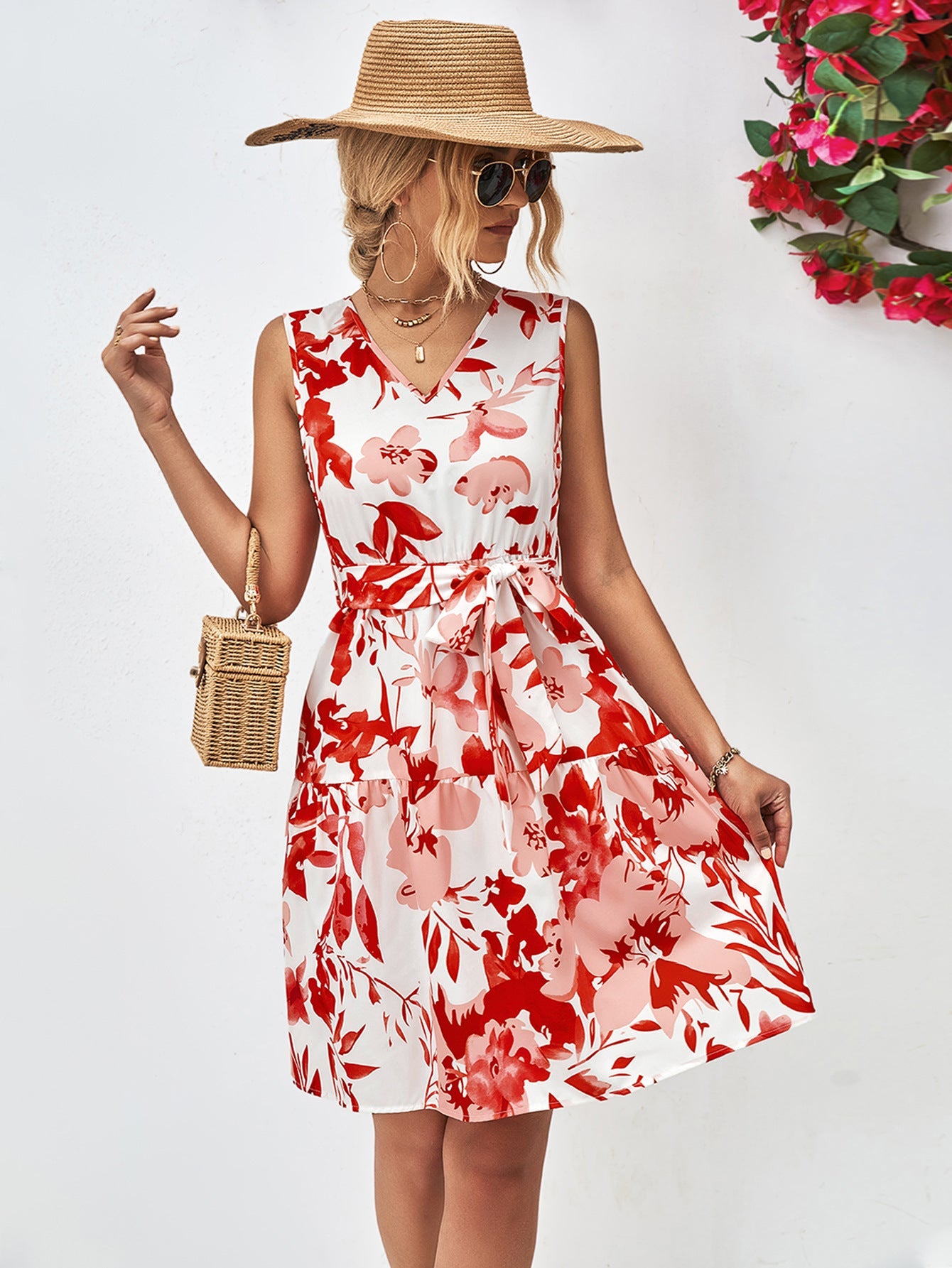 Watercolor floral tiered mini dress in red and pink, with V-neck and tie waist.