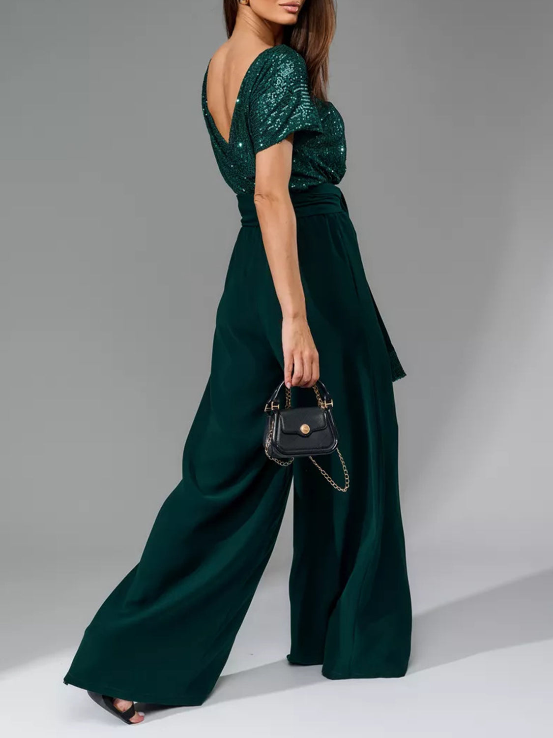 Dark green sequin bodice with a deep V-neck and matching palazzo pants.