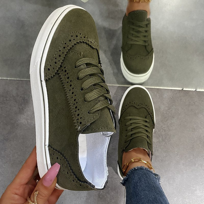 Green matte finish lace-up sneakers with brogue detailing and white soles.