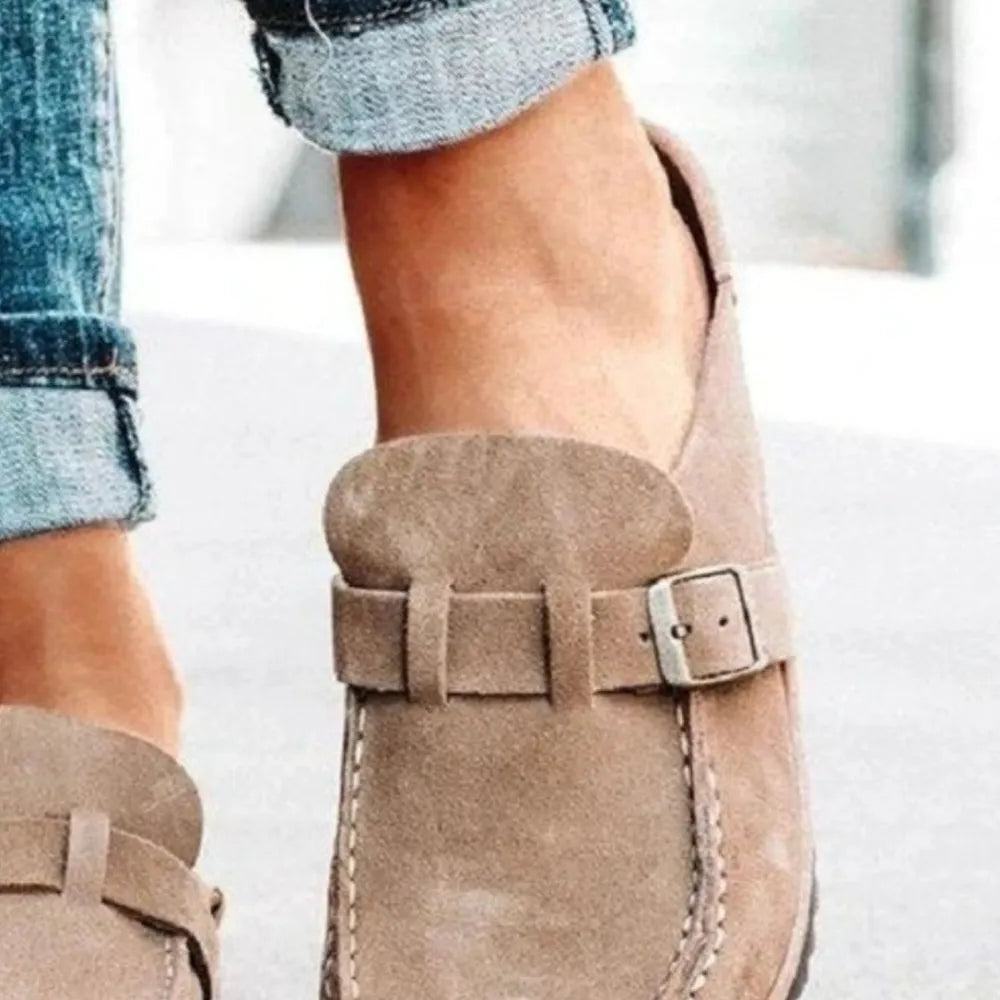 Caramel suede buckle mule loafers with a silver buckle detail.