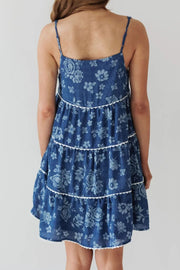 Floral denim sundress in medium with tiered skirt and white trim.