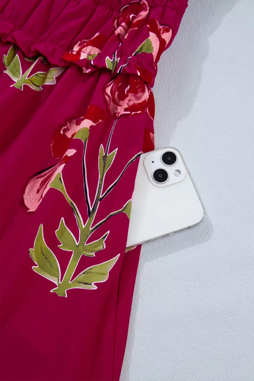 Charming floral tiered midi dress in magenta with a pocket holding a white smartphone.