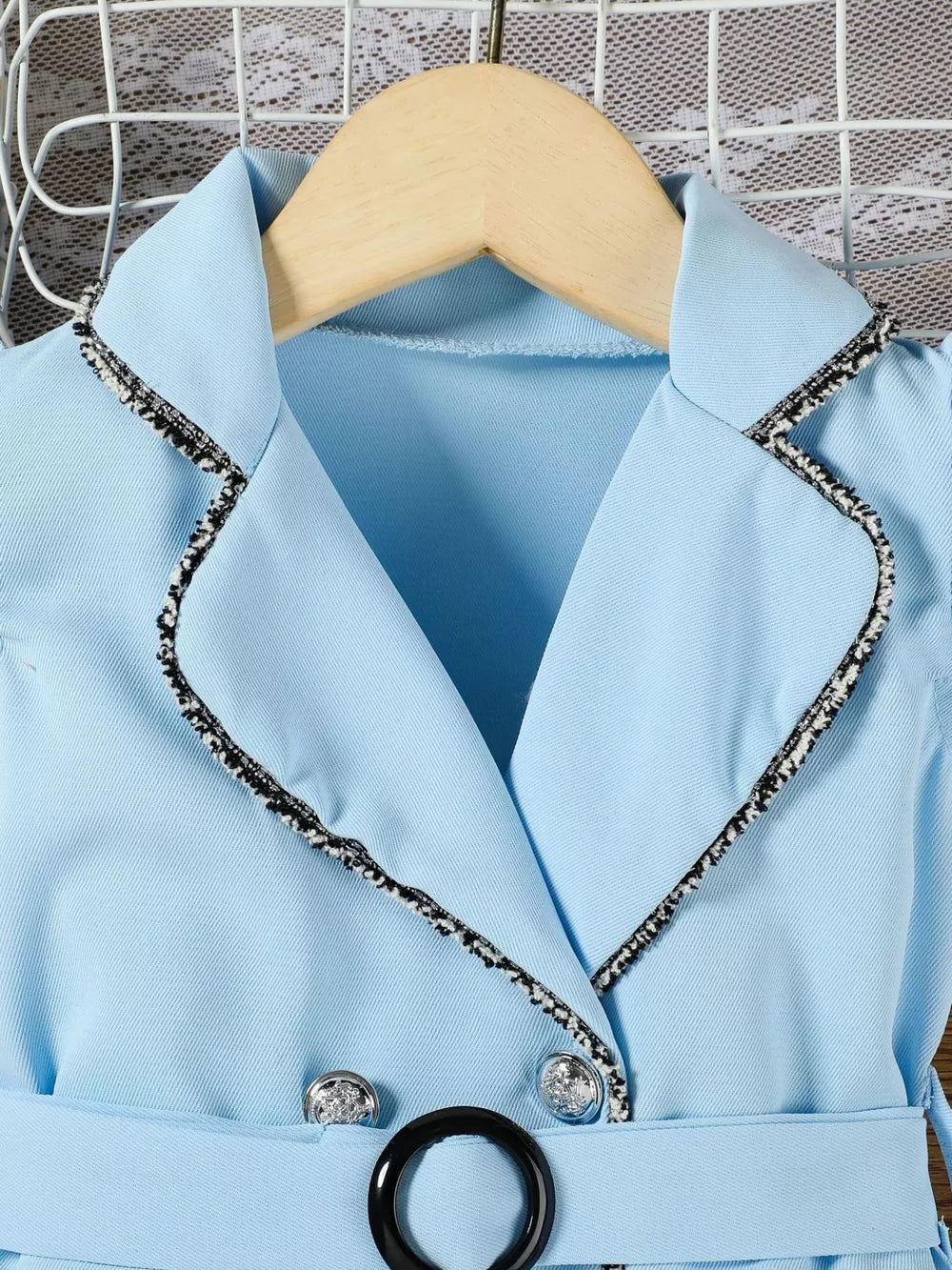 Sky blue toddler dress with double-breasted detail, black trim, and belted waist.