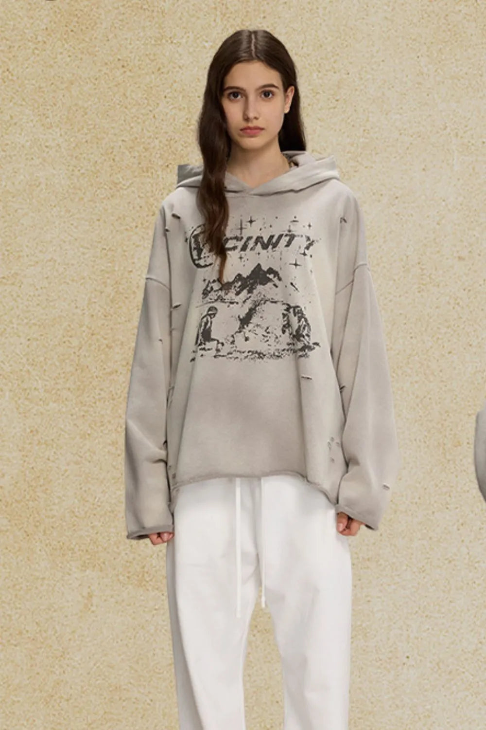 Gray distressed oversized hoodie with graphic print and raw hem