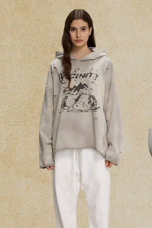 Gray distressed oversized hoodie with graphic print and raw hem