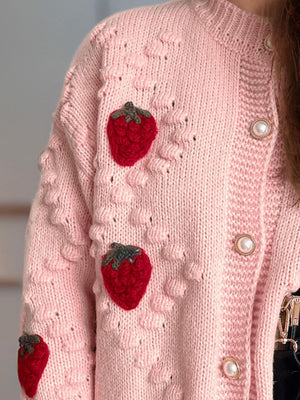 Pink knit cardigan with strawberry appliques and pearl buttons